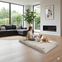 Happy Animalia beige plush dog bed with a woman and dog relaxing on it in a modern living room.