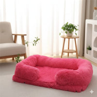 Happy Animalia plush dog and cat bed in bright pink, with raised edges for comfort and security. Soft, fluffy material.