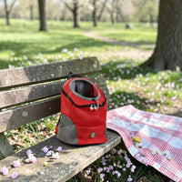 Happy Animalia red and grey mesh dog hiking backpack with head opening and safety straps, perfect for travel.