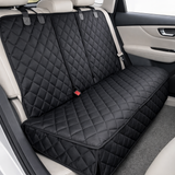 Vue d'ensemble d'une housse de protection noire et matelassée installée sur la banquette arrière d'une voiture aux sièges en cuir beige, fixée aux appuis-tête.